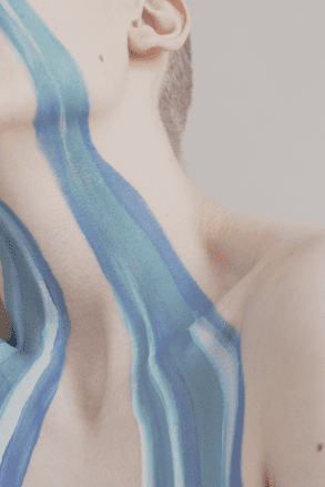 An abstract crop of a river of painted tears running down a woman's face.