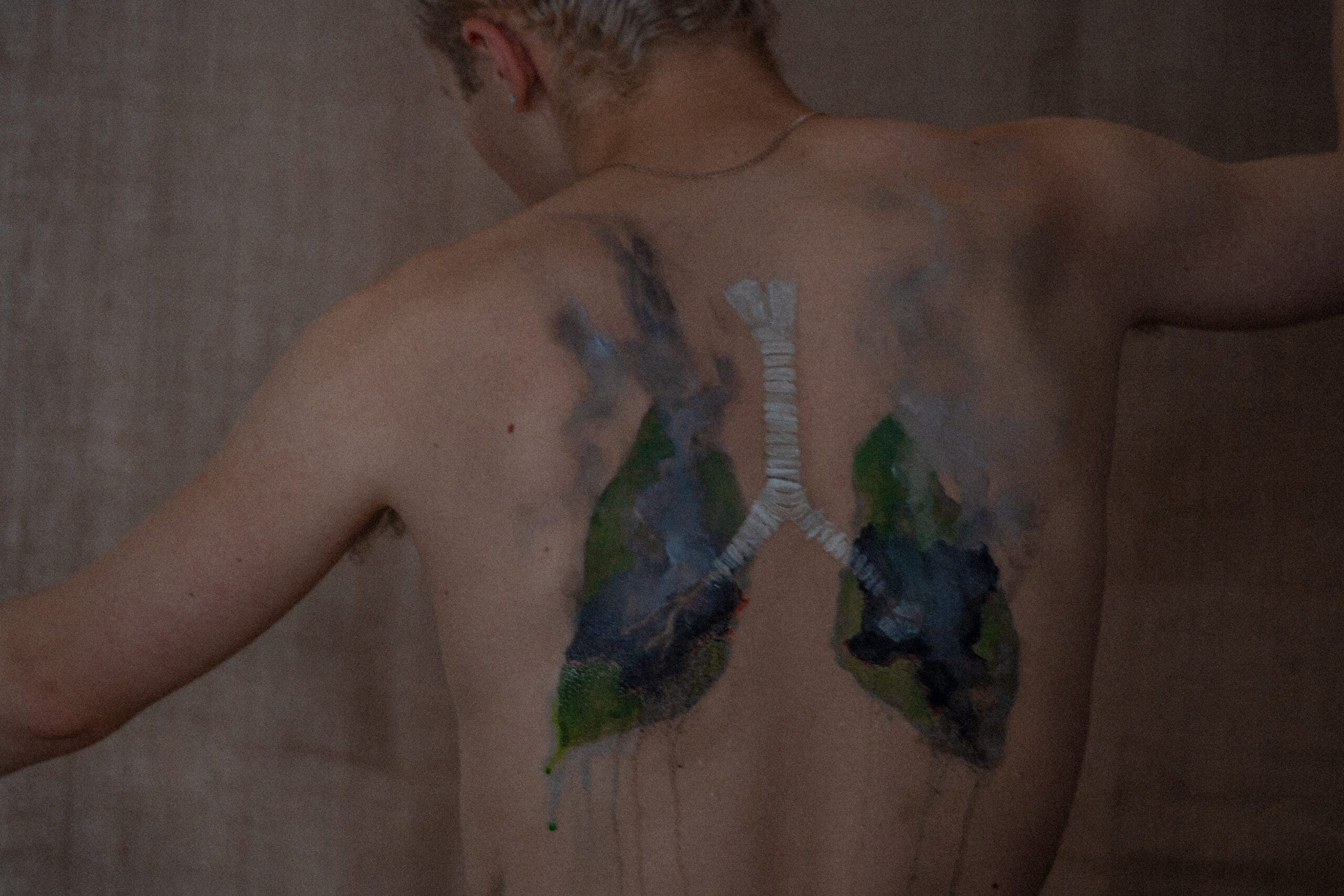 Lungs, in the shape of the Amazon and central Africa painted on a young White man's back