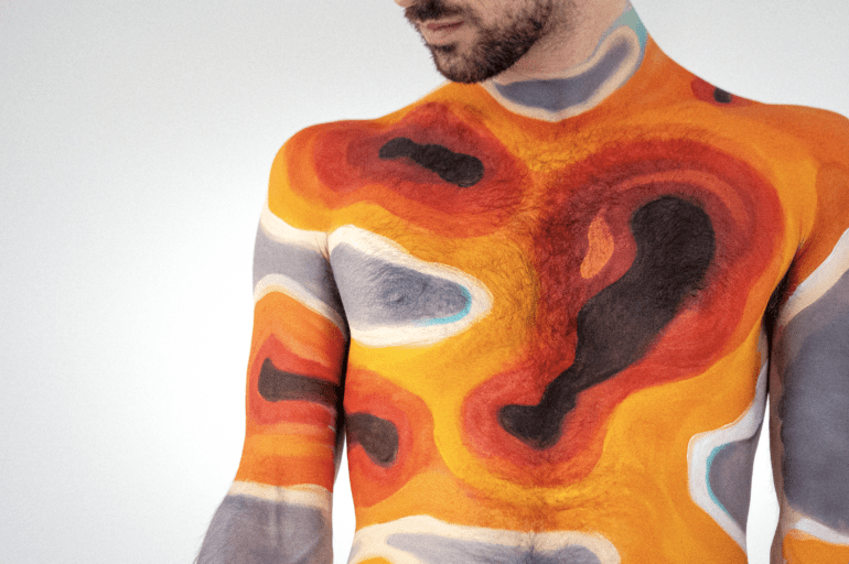 A climate heat map painted on the arms and torso of a man's body.