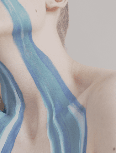 An abstract crop of a river of painted tears running down a woman's face.